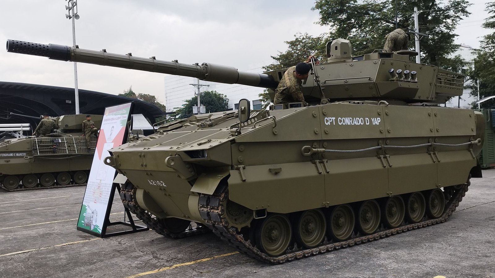 ASCOD II Sabrah light tank during 88th Armed Forces of the Philippines anniversary celebrations. 21 December 2023, 12:07 local camera time. coordinates on file page 14.611772, 121.062525, Quezon City/Camp Aguinaldo area. side/front angle, Shows hull and turret proportions.