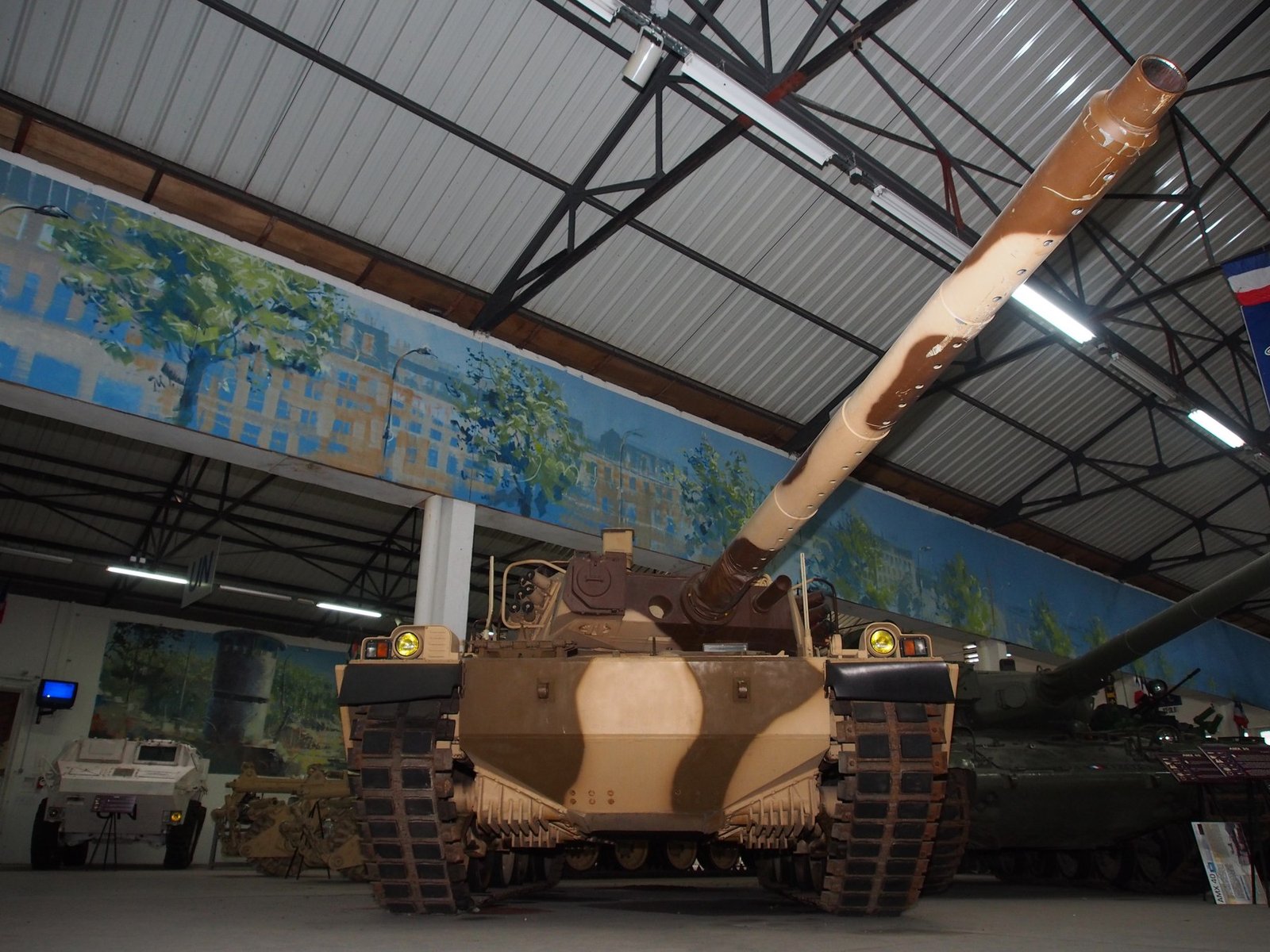 Low front view of the preserved AMX-40 with the 120 mm gun elevated. This angle highlights the sharply sloped glacis, track width, and frontal profile. 2013-09-11. Musée des Blindés, Saumur, France. Source/. preserved vehicle; exact prototype/pre-series identity follows museum identification rather than Commons metadata.