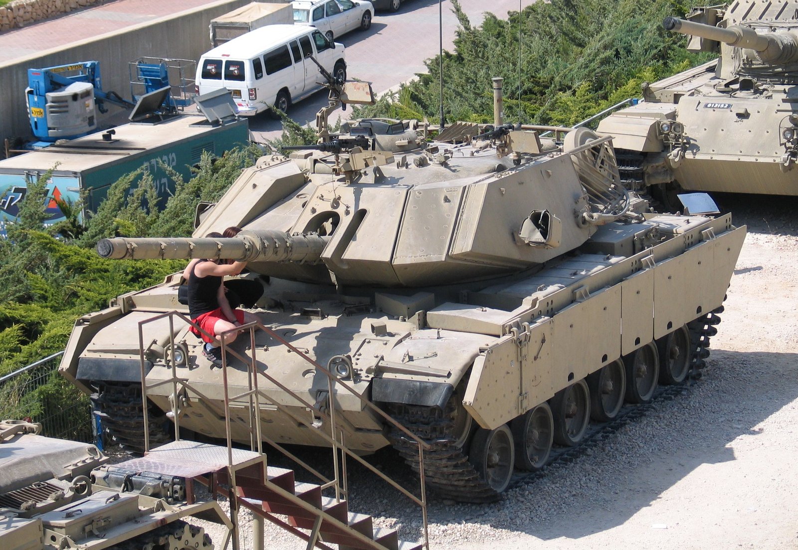 M60 / Magach 7 with M9 dozer blade at Yad La-Shiryon, Israel. 8 May 2008. illustrates dozer-equipped/security or obstacle-clearing configuration; museum vehicle with surrounding exhibits.