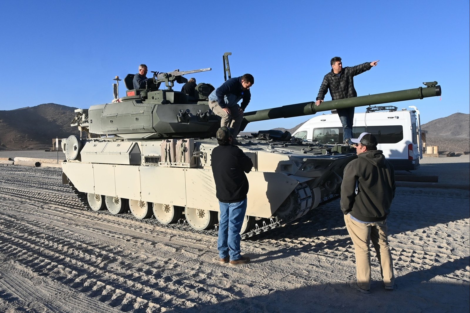 Personnel inspect or work around an M10 Booker during Yuma Proving Ground testing, published 12 February 2025.