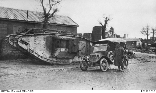 British Mark IV tank Henry with a Ford Model T at Bapaume in 1918; Australian War Memorial P01322.010.