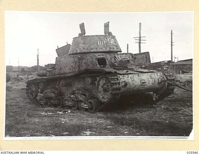 Damaged Italian Carro Armato M13/40 captured by the AIF in Libya and brought to Fishermens Bend, Victoria, for examination, July 1942. Shows technical-intelligence and damage discussion. [AWM-025546].