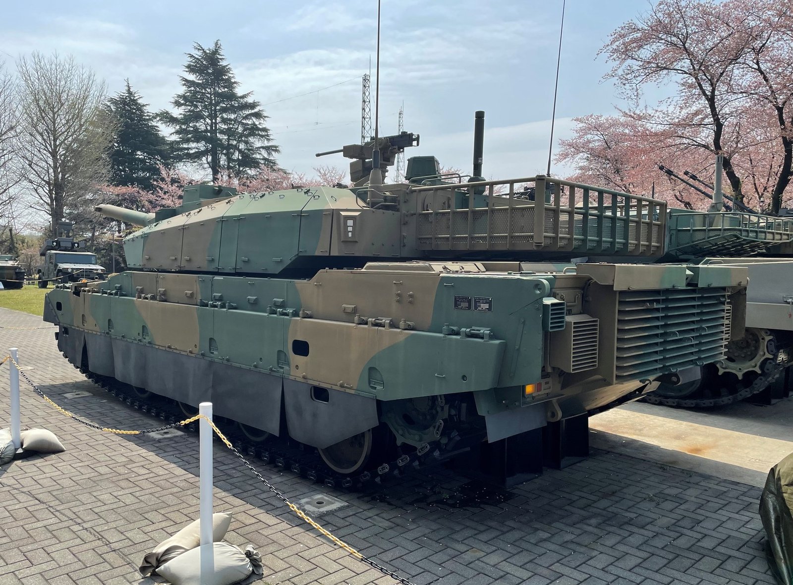 Rear view of Type 10 prototype at JGSDF Public Information Center. Prototype Type 10 main battle tank. 7 April 2022. JGSDF Public Information Center, Camp Asaka, Asaka City, Saitama Prefecture, Japan. Museum/public-information-center display. Use as prototype/survivor reference, not as a fielded production vehicle photo.