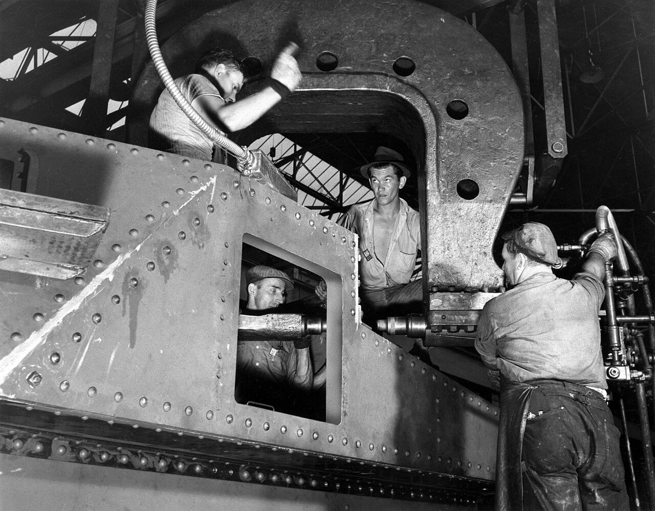 Riveting work on an M3 tank at the Chrysler Tank Arsenal, Detroit, 1940-1946. production scene rather than completed vehicle photograph. [Commons-Palmer-Riveting].