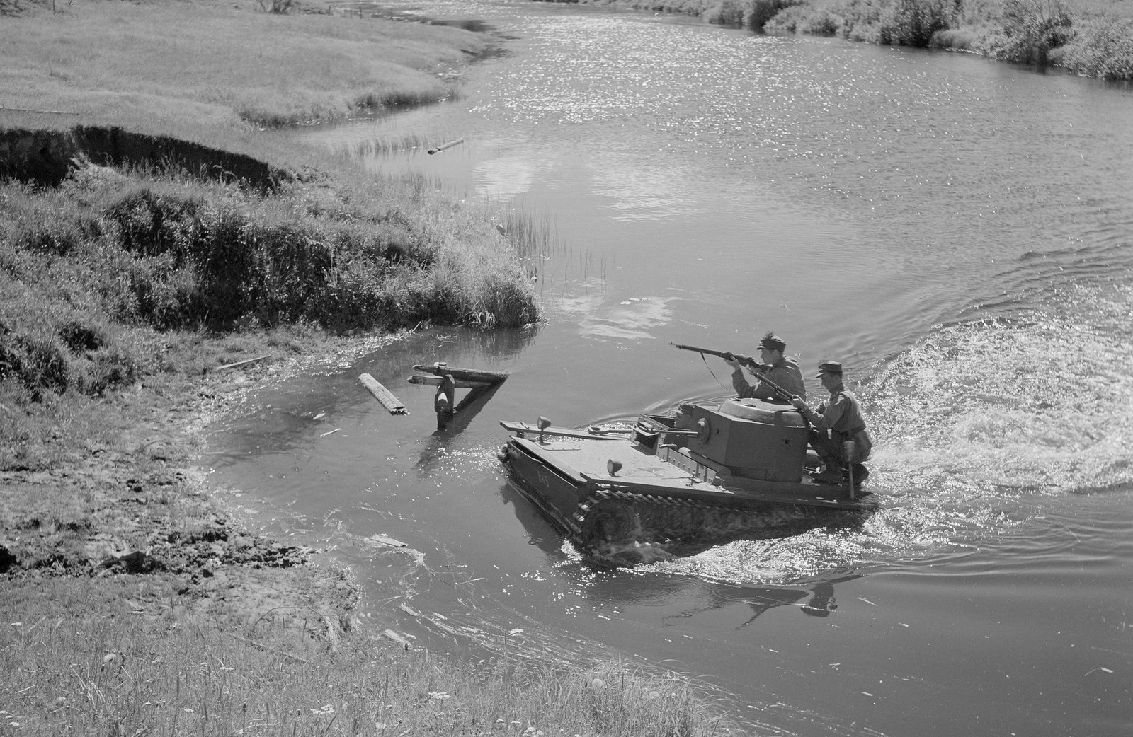 A vehicle identified as T-38 crossing a small watercourse in Finnish handling.