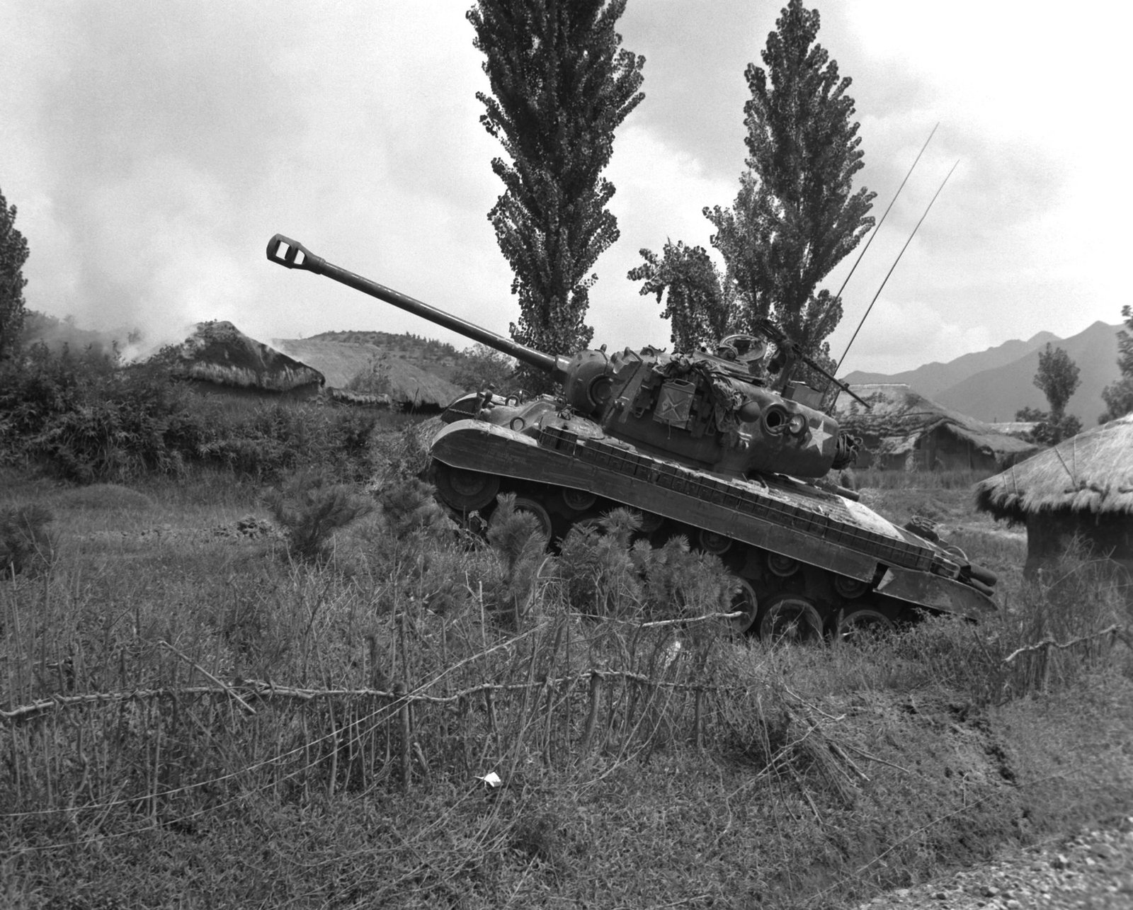 U.S. Marine Pershing tank moving around a Korean village during operations against North Korean armor, 4 September 1950. Korea, village not identified in Commons metadata. caption wording follows source metadata; not used to identify a specific tank company without further archival confirmation.