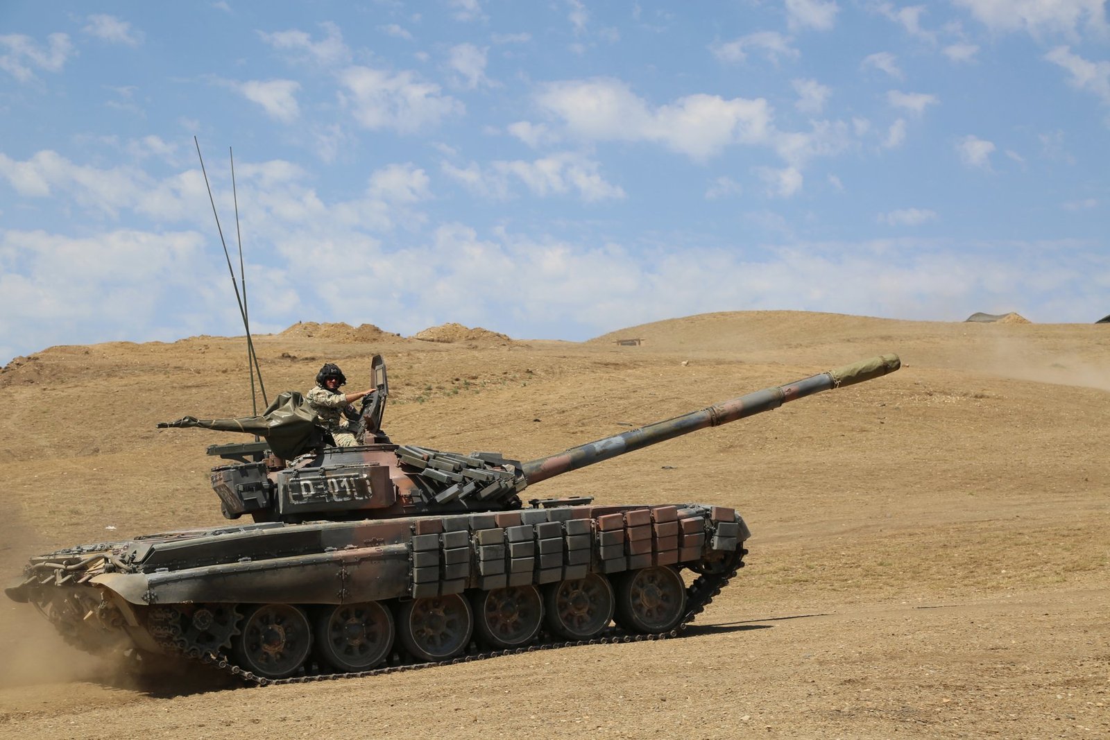 Georgian T-72 SIM-1 side view moving during Noble Partner 17. Vehicle / variant identification: Georgian Armed Forces T-72 SIM-1 / upgraded T-72. 6 August 2017 (metadata date 5 August 2017, 20:00). Vaziani, Republic of Georgia. Good side view of ERA coverage and antenna layout.