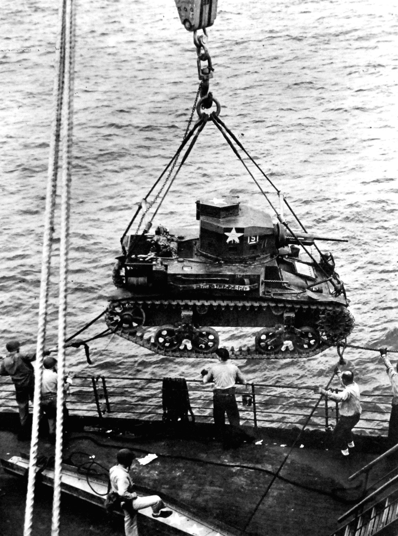 M2A4 Light Tank "Blizzard" hoisted from USS Alchiba into a landing craft off Guadalcanal, 7 August 1942. Guadalcanal invasion beaches.