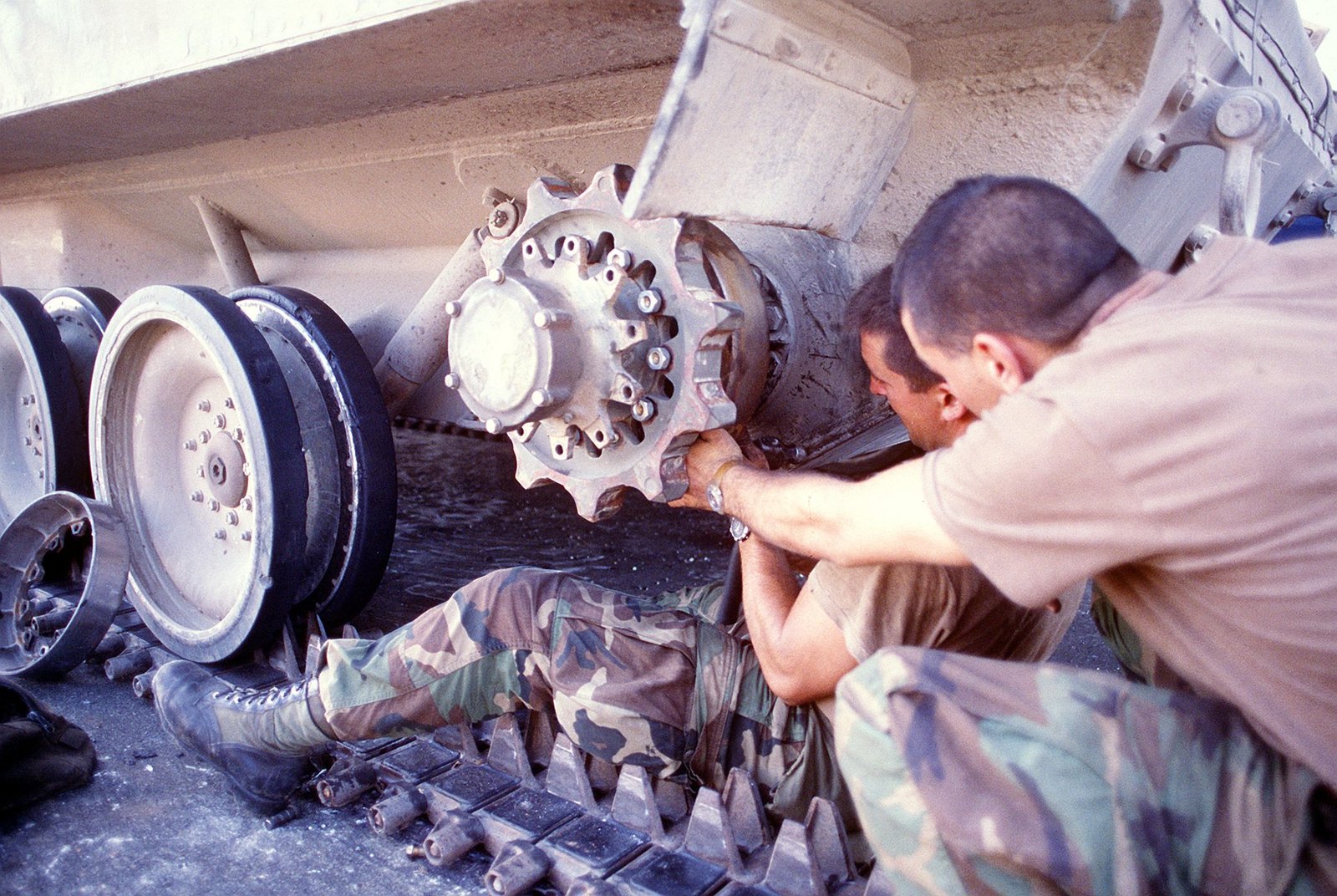 Two members of the 82nd Airborne Division repair the left drive sprocket on an M-551 Sheridan at Tocumen, Panama, after Operation Just Cause. The image is useful evidence for maintenance realities after airborne assault operations.