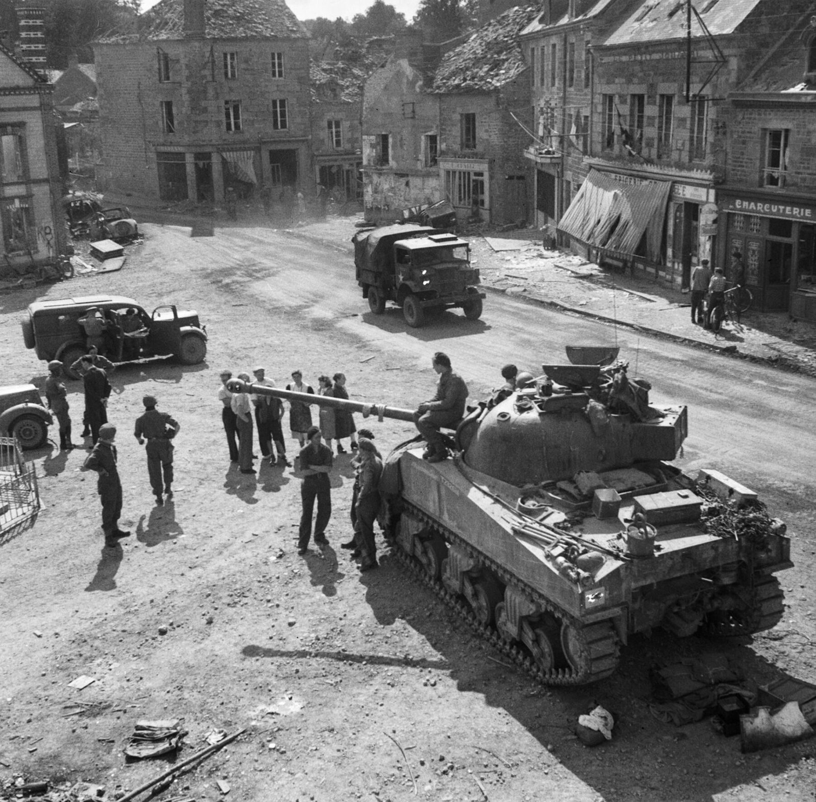 Sherman Firefly and other vehicles at Putanges, Normandy, 20 August 1944.