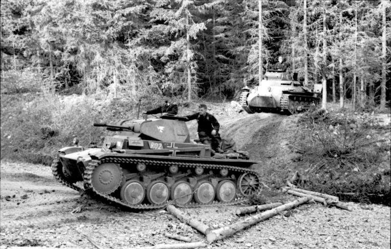 Panzer II and Panzer I in the West, May 1940. Vehicle/variant identification: foreground Panzer II, rear Panzer I; exact Panzer II Ausf. uncertain from image alone. Date/. Western campaign, May 1940; wooded road. Source/.