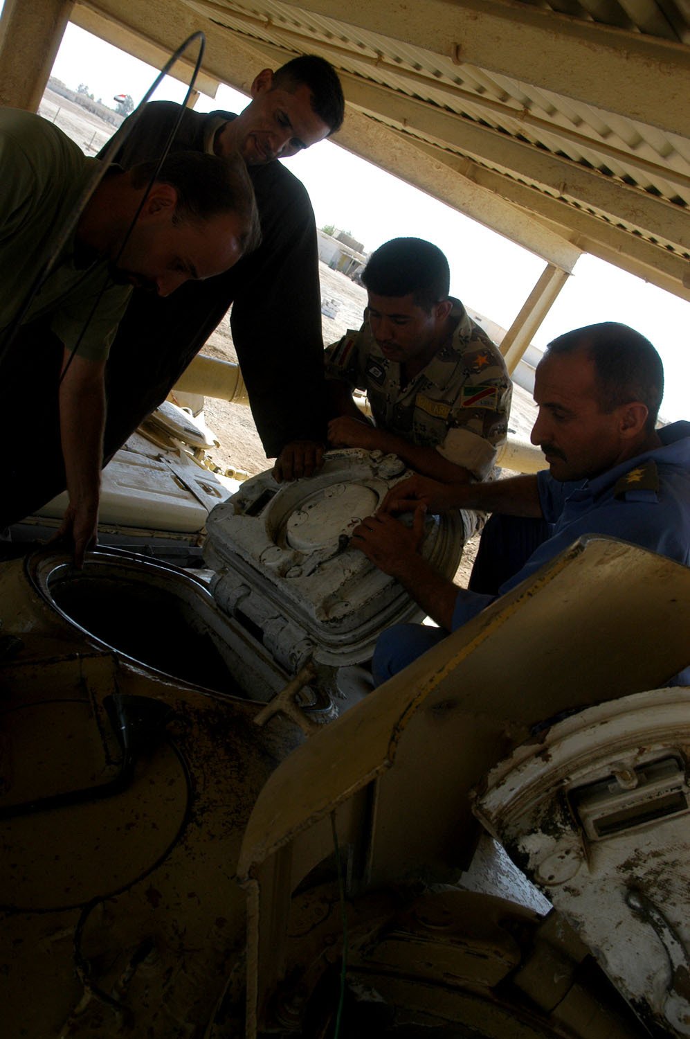 Czech Republic army contingent soldiers and Iraqi Army soldiers work to repair a T-72 Main Battle Tank, “Lion of Babylon,” at Camp Taji, Iraq, 4 October 2008. Vehicle/variant identification: DVIDS caption calls it a T-72 Main Battle Tank, “Lion of Babylon.”. maintenance scene; Shows post-2003 legacy rather than original production proof.