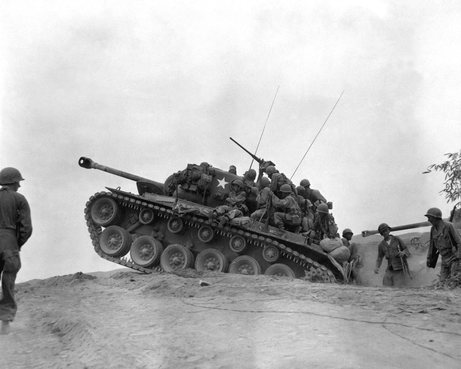 Men of the 9th Infantry Regiment ride/man an M26 Pershing during fighting near the Naktong River, 3 September 1950. Naktong River area, Korea. illustrates infantry riding a Pershing in Korea; tactical situation caption from Commons metadata.