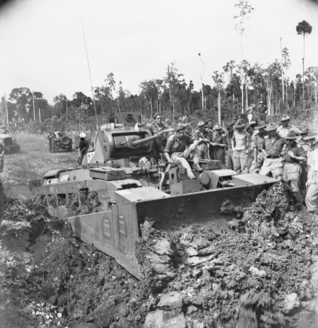Australian Matilda fitted with a bulldozer blade during a demonstration on Morotai, 9 June 1945; the blade was operated by a Jeep engine.
